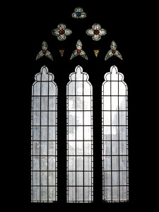 Fire-damaged CE Kempe stained glass in the north transept, 1892. Kempe and Tombleson trademarks remain in the tracery at the top.