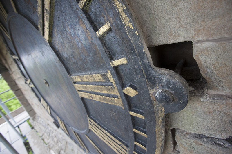 Close up of unsecured clock face mounting bolt