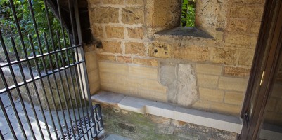 Repaired porch showing repositioned headstone