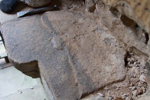 Close up of uncovered fragment of ancient headstone